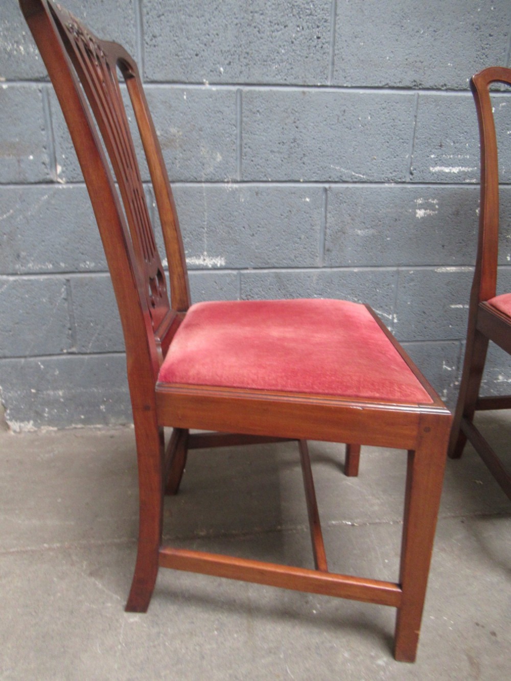 A set of four Edwardian mahogany dining chairs with carved pierced back splats and red velvet upholstered seats. View VII