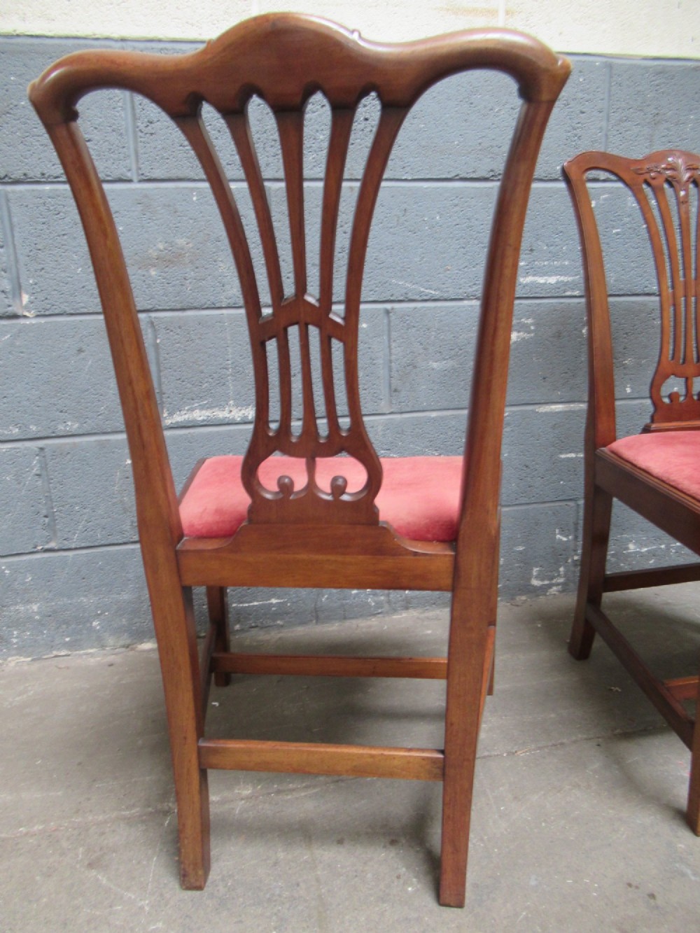A set of four Edwardian mahogany dining chairs with carved pierced back splats and red velvet upholstered seats. View VIII
