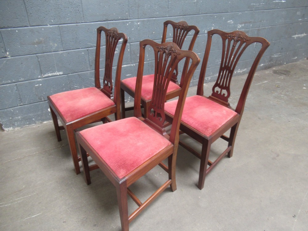 A set of four Edwardian mahogany dining chairs with carved pierced back splats and red velvet upholstered seats. View IX