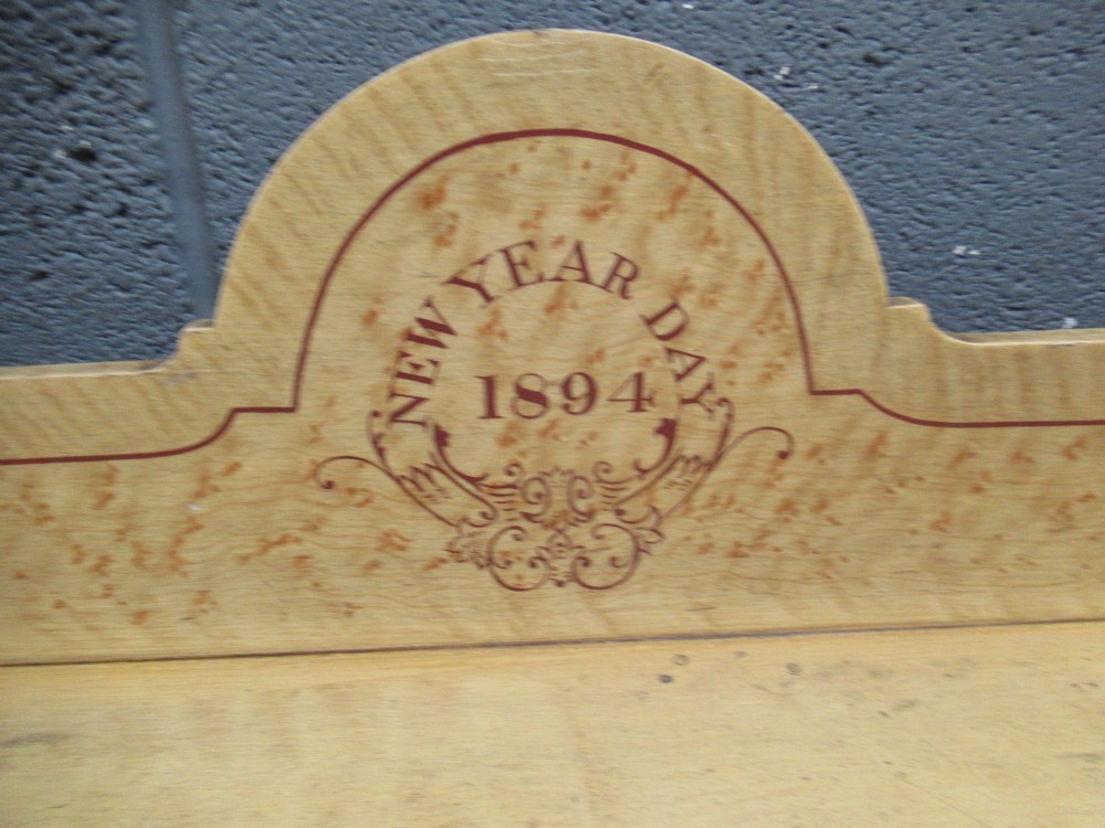 A Victorian painted pine chest of drawers with two short over two long drawers, decorated with scumbled graining, red stencilled borders, turned wooden knobs, and an upstand inscribed New Year Day 1894. View IV