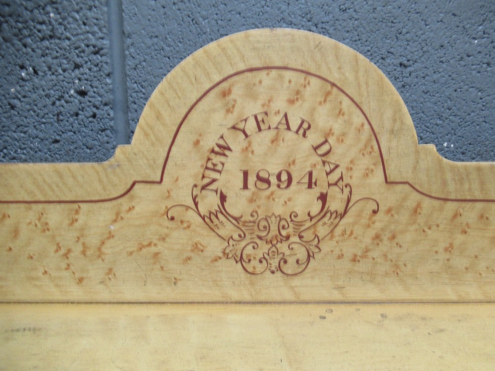 A Victorian painted pine chest of drawers with two short over two long drawers, decorated with scumbled graining, red stencilled borders, turned wooden knobs, and an upstand inscribed New Year Day 1894. View V