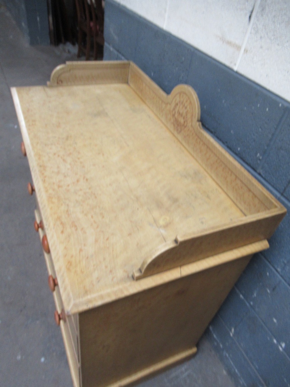A Victorian painted pine chest of drawers with two short over two long drawers, decorated with scumbled graining, red stencilled borders, turned wooden knobs, and an upstand inscribed New Year Day 1894. View VIII