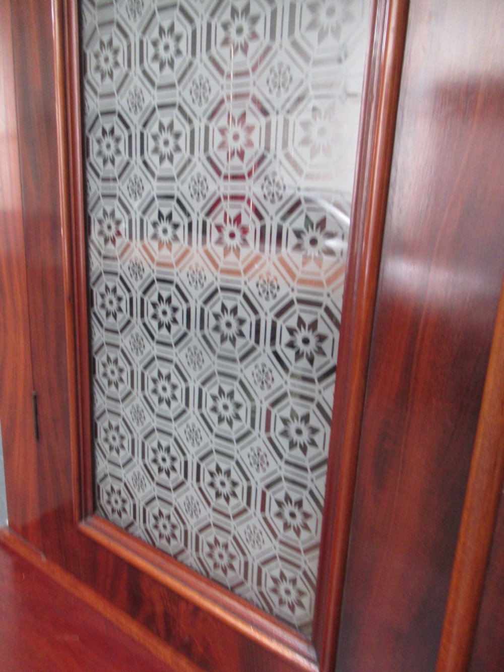 A tall 19th-century Victorian mahogany glazed bookcase featuring a two-door upper section above a lower cupboard base with carved corbels. View IX