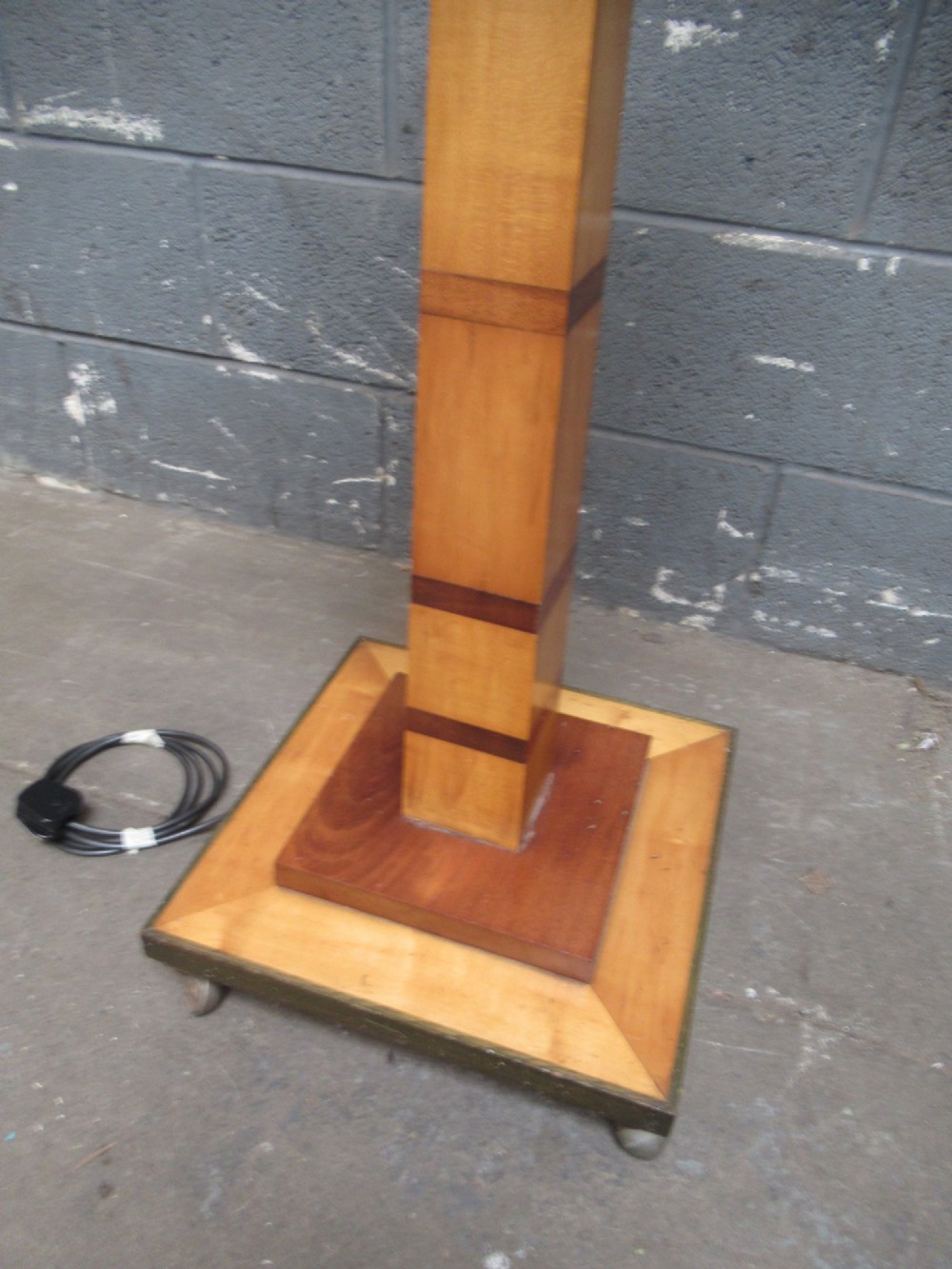 An Art Deco floor lamp crafted from geometric timber marquetry, featuring a central square tray table, a tall square column, and a stepped brass-rimmed base. View III