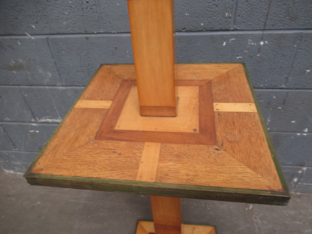 An Art Deco floor lamp crafted from geometric timber marquetry, featuring a central square tray table, a tall square column, and a stepped brass-rimmed base. View IV