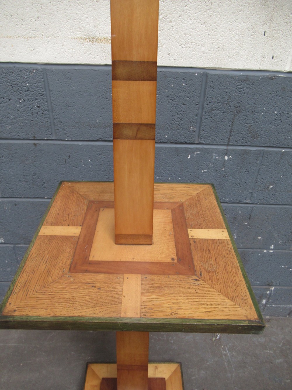 An Art Deco floor lamp crafted from geometric timber marquetry, featuring a central square tray table, a tall square column, and a stepped brass-rimmed base. View V