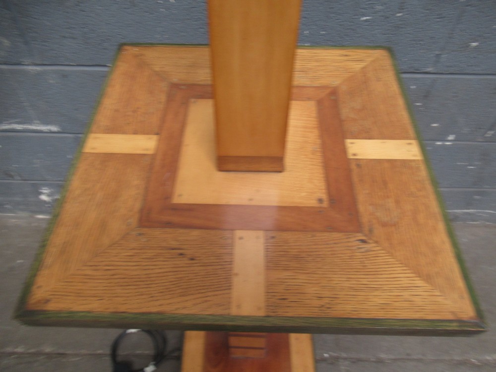 An Art Deco floor lamp crafted from geometric timber marquetry, featuring a central square tray table, a tall square column, and a stepped brass-rimmed base. View VII