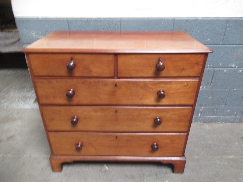 A Victorian mahogany chest of drawers with two short drawers over three long drawers, turned handles, and bracket feet. View II