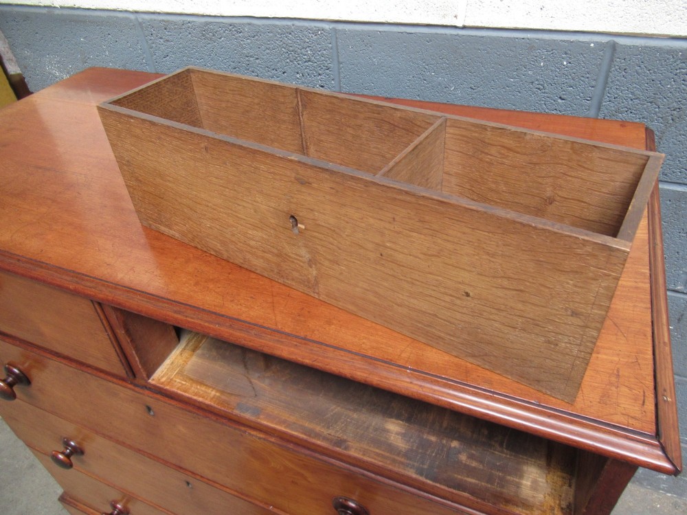 A Victorian mahogany chest of drawers with two short drawers over three long drawers, turned handles, and bracket feet. View X