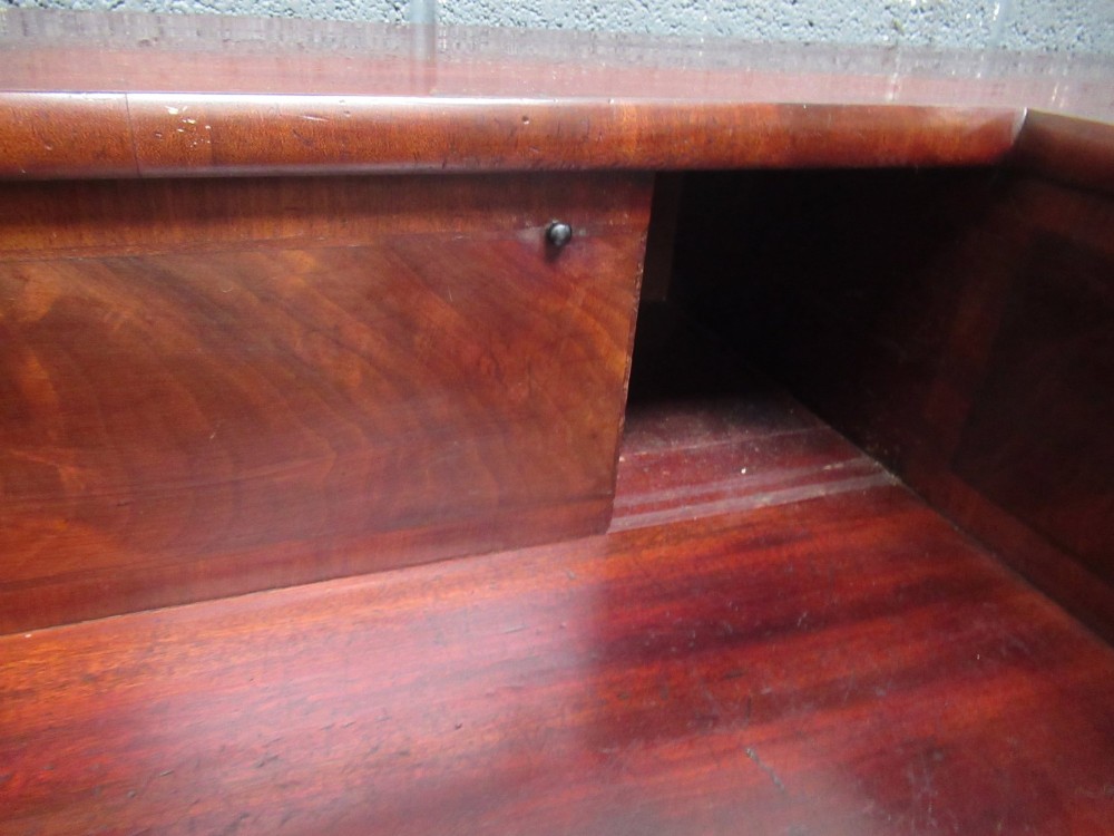 An early 19th century Scottish mahogany sideboard featuring a raised stage back, pedestal cupboards, central drawers, and spiral turned legs. View VII