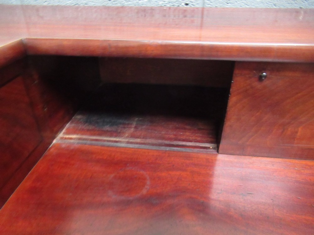 An early 19th century Scottish mahogany sideboard featuring a raised stage back, pedestal cupboards, central drawers, and spiral turned legs. View VIII