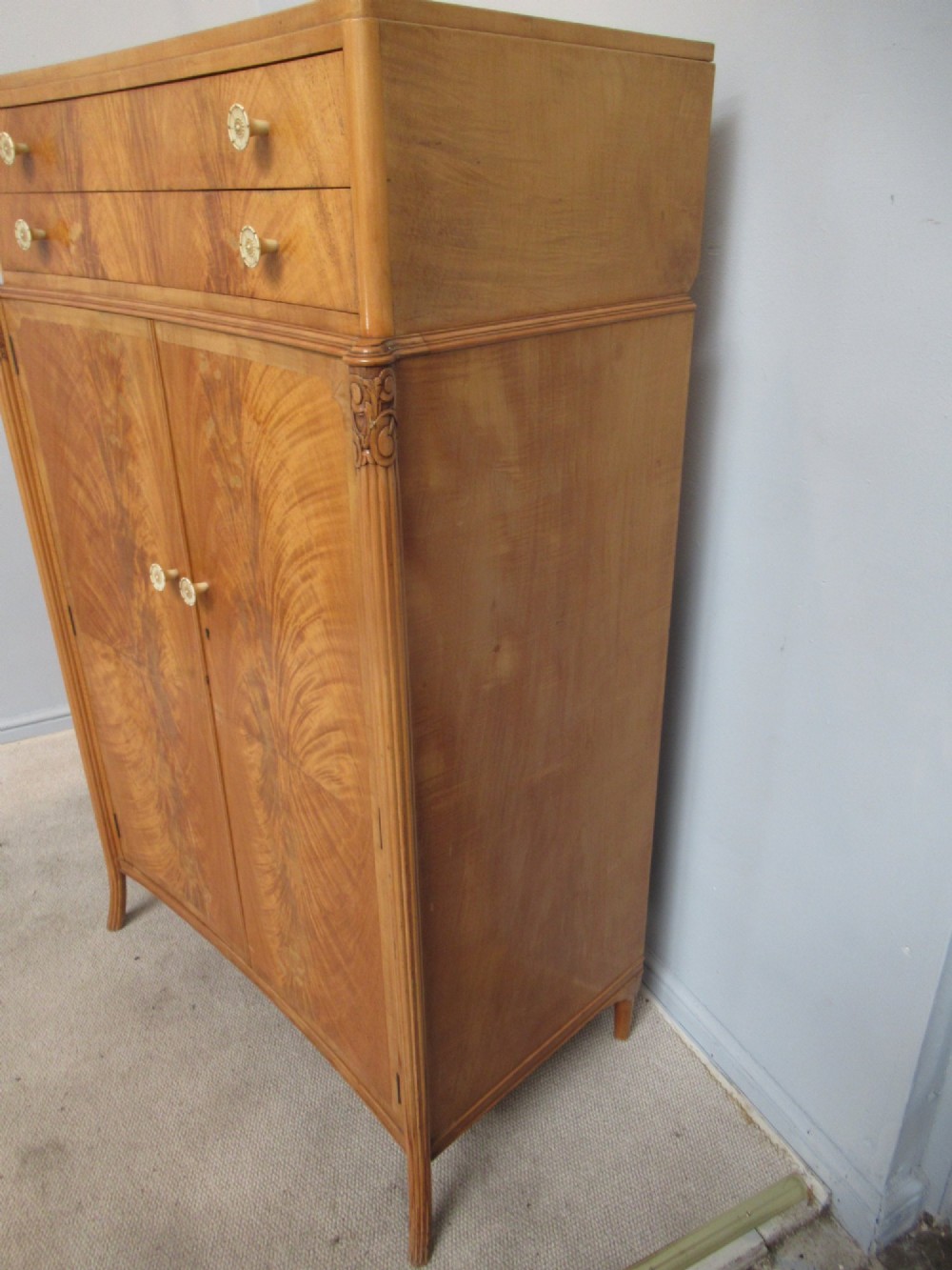 A mid-century fitted tallboy cabinet in pale mahogany and maple featuring two top drawers above double doors opening to reveal internal sliding shirt trays. View IV
