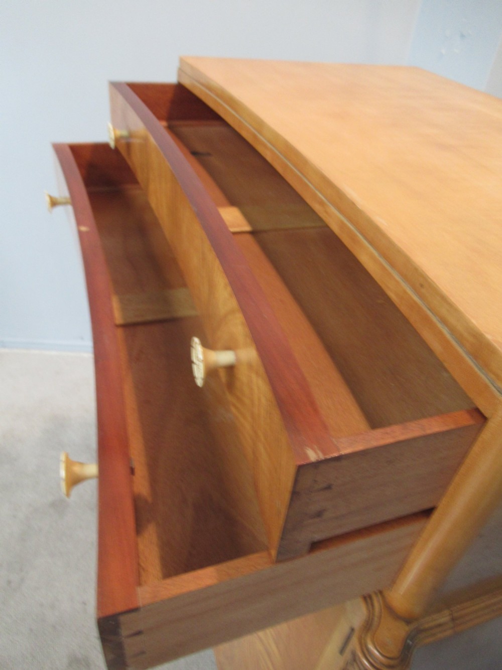 A mid-century fitted tallboy cabinet in pale mahogany and maple featuring two top drawers above double doors opening to reveal internal sliding shirt trays. View VI