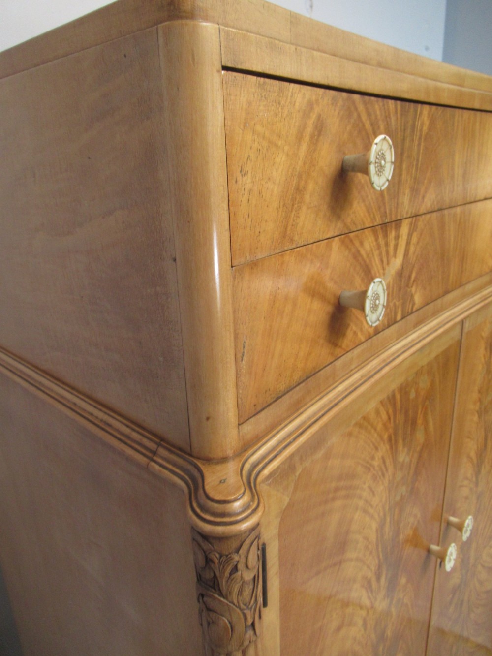 A mid-century fitted tallboy cabinet in pale mahogany and maple featuring two top drawers above double doors opening to reveal internal sliding shirt trays. View X