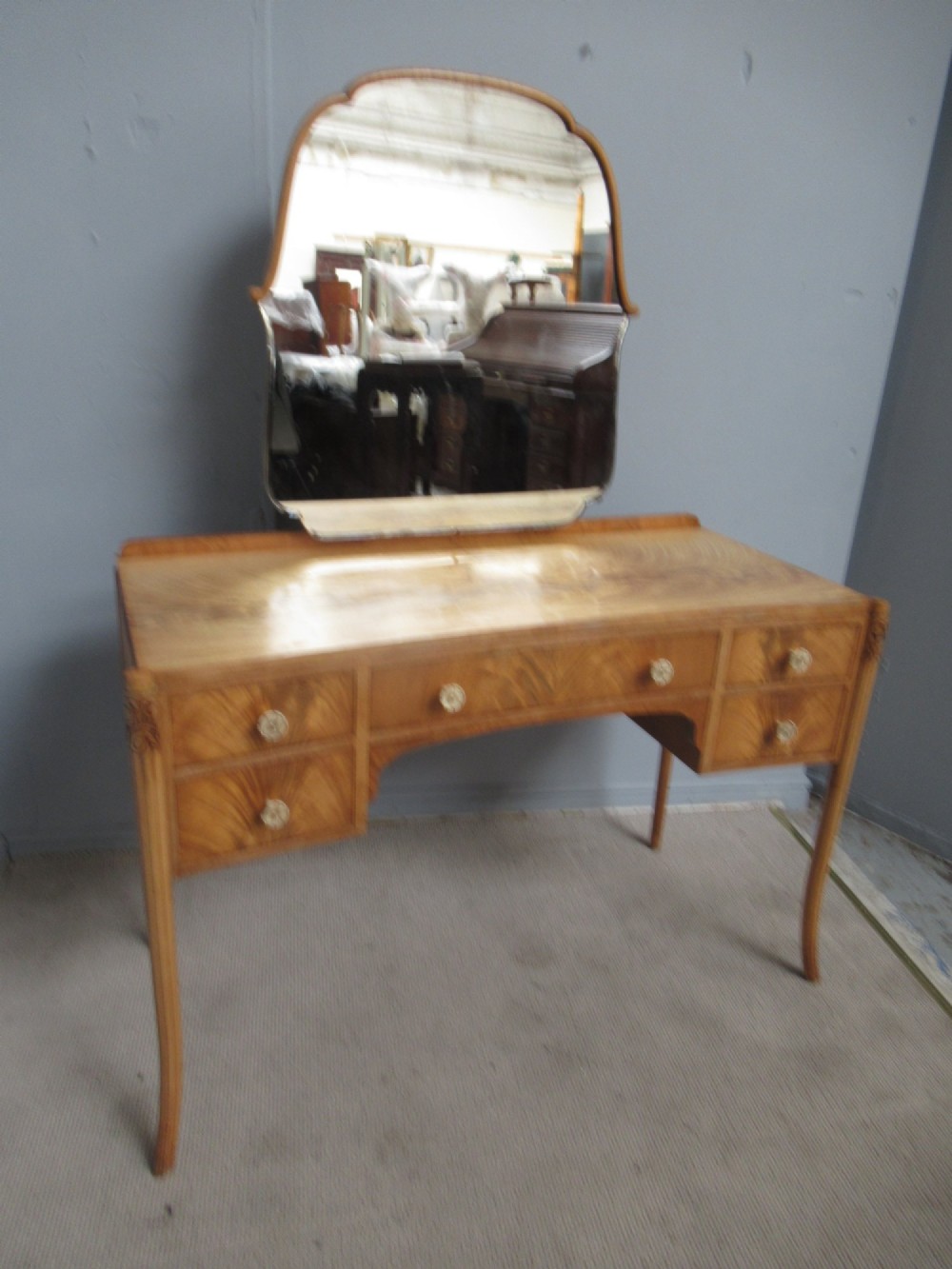 A 1930s Art Deco dressing table made from pale mahogany and maple, featuring an attached arched mirror, five drawers, and slender carved legs. View XI