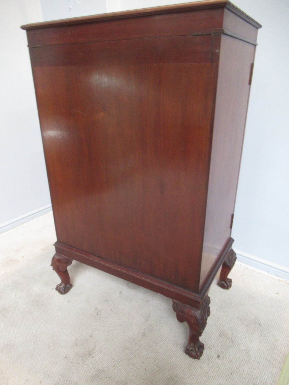 A mahogany Chippendale style cocktail cabinet shown open, revealing a mirrored interior, glass rack holders, and carved cabriole legs with ball-and-claw feet. View VIII