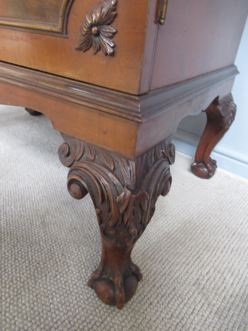 A mahogany Chippendale style cocktail cabinet shown open, revealing a mirrored interior, glass rack holders, and carved cabriole legs with ball-and-claw feet. View IX
