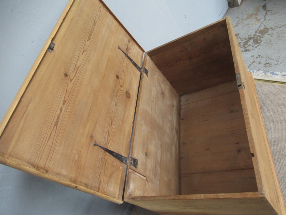 A nineteenth-century pine blanket box featuring a hinged lid, brass escutcheon, and bracket feet. View VII