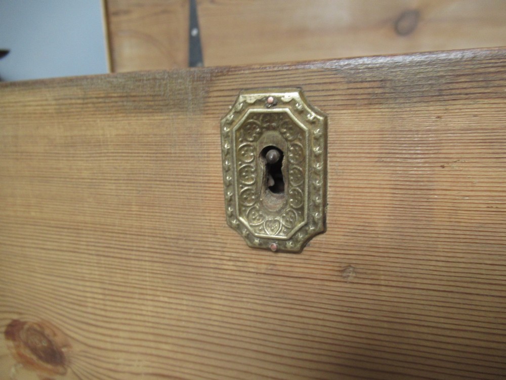 A nineteenth-century pine blanket box featuring a hinged lid, brass escutcheon, and bracket feet. View VIII