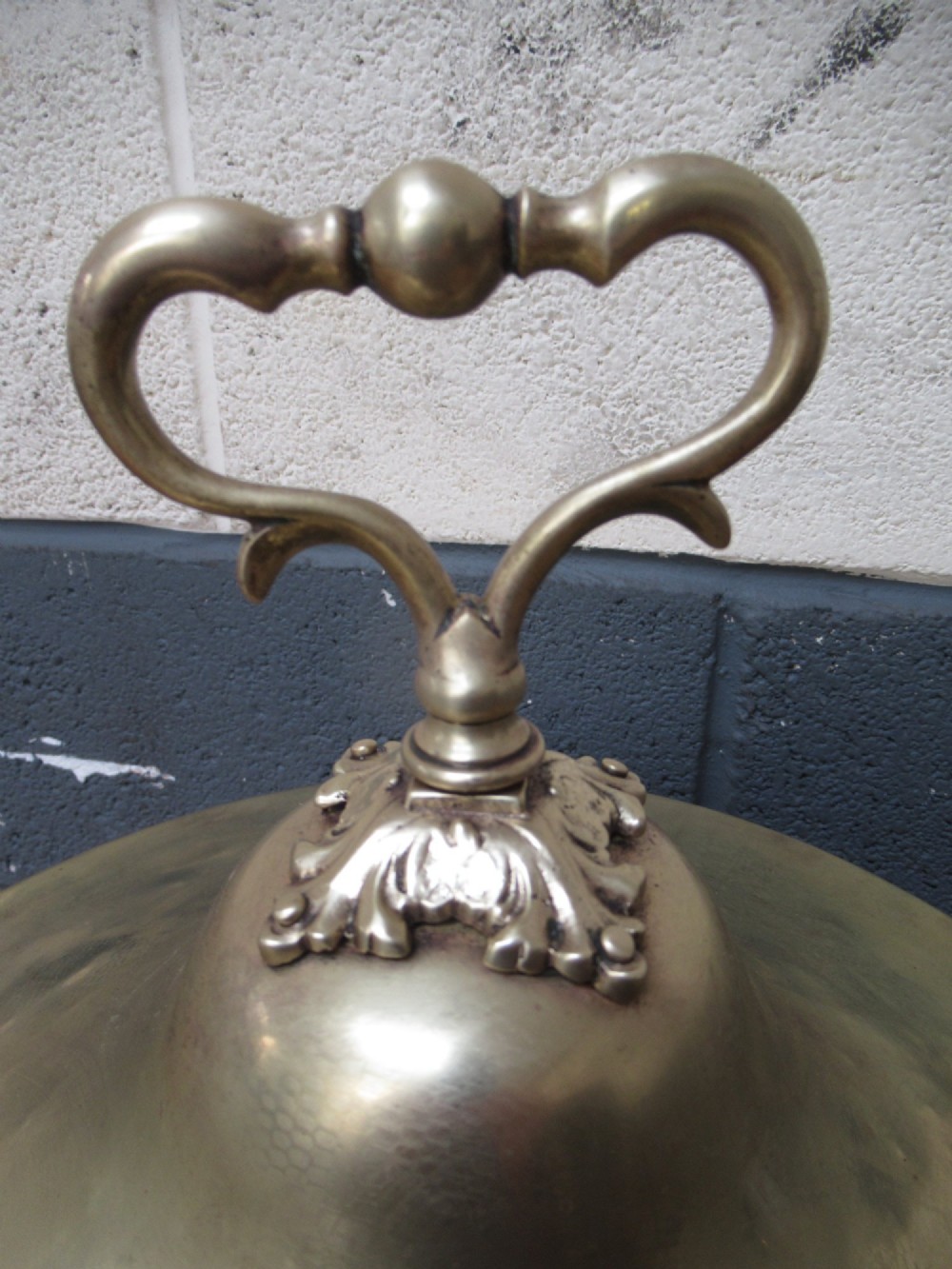 A polished brass lidded decorative bucket with a finial handle, lion mask side rings, and ornate claw feet. View III