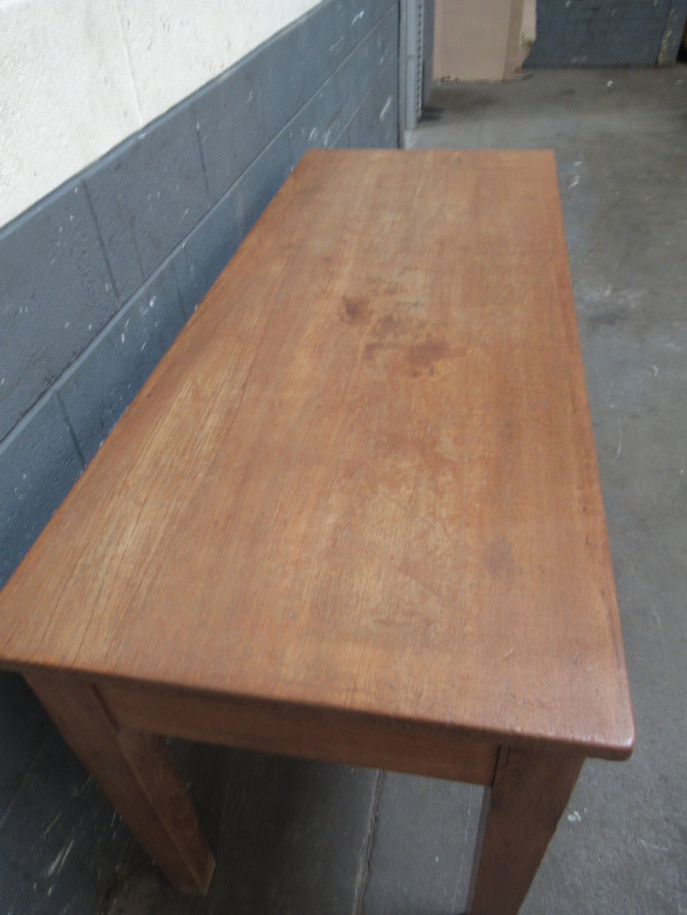 A light oak side table featuring a wide rectangular top, two drawers with brass cup handles, and four straight legs. View III