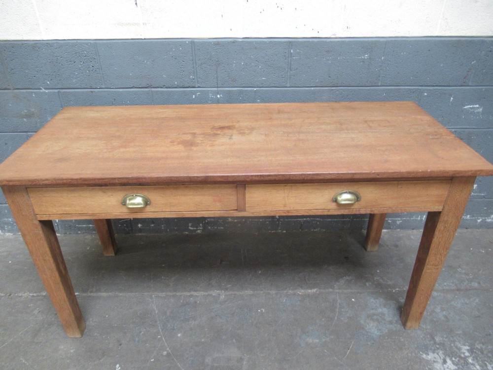 A light oak side table featuring a wide rectangular top, two drawers with brass cup handles, and four straight legs. View IX
