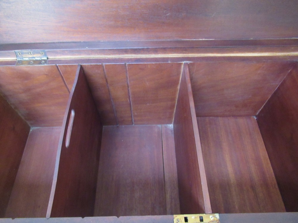 An open mahogany fitted storage chest with internal vertical wood dividers, a keyhole with a dark escutcheon, and a hinged lid. View VI