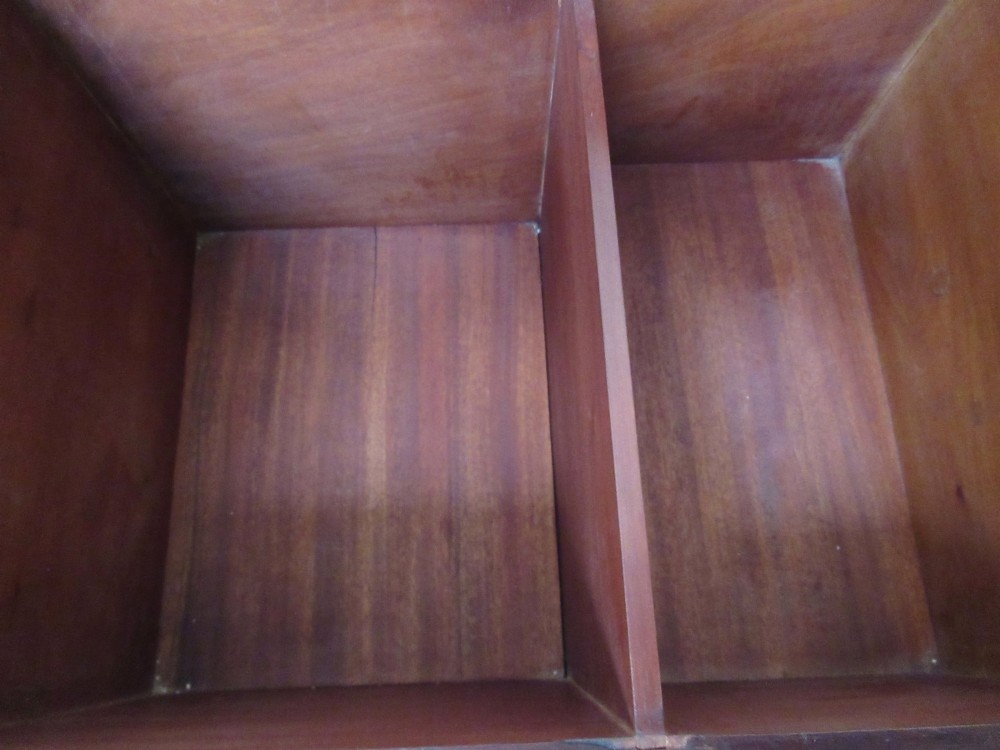 An open mahogany fitted storage chest with internal vertical wood dividers, a keyhole with a dark escutcheon, and a hinged lid. View VII