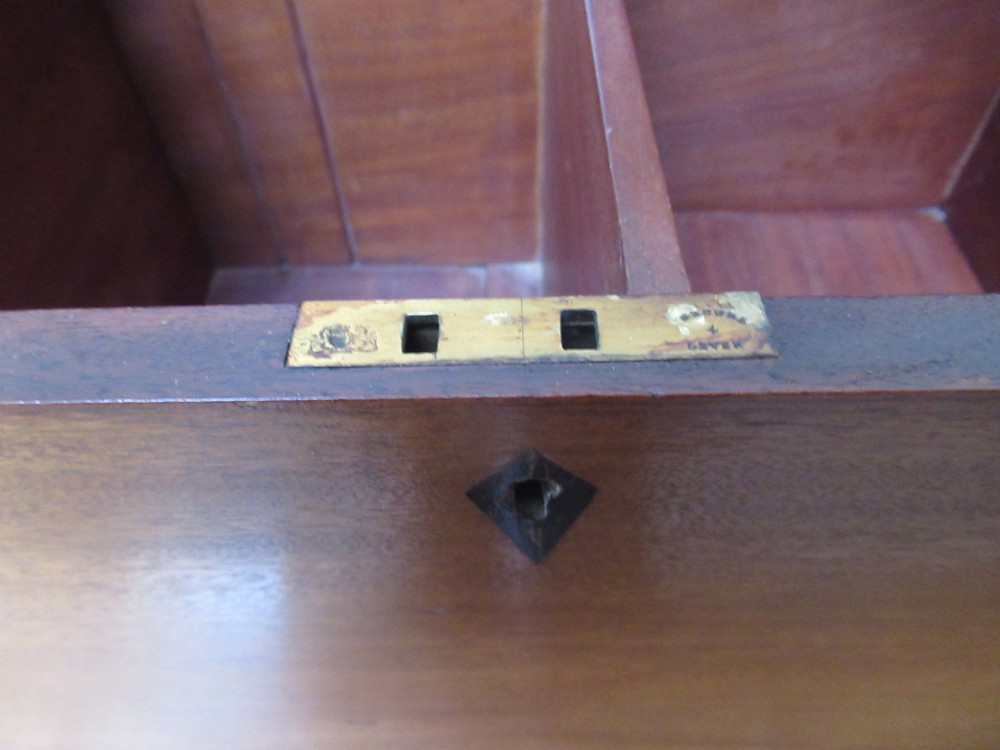 An open mahogany fitted storage chest with internal vertical wood dividers, a keyhole with a dark escutcheon, and a hinged lid. View VIII