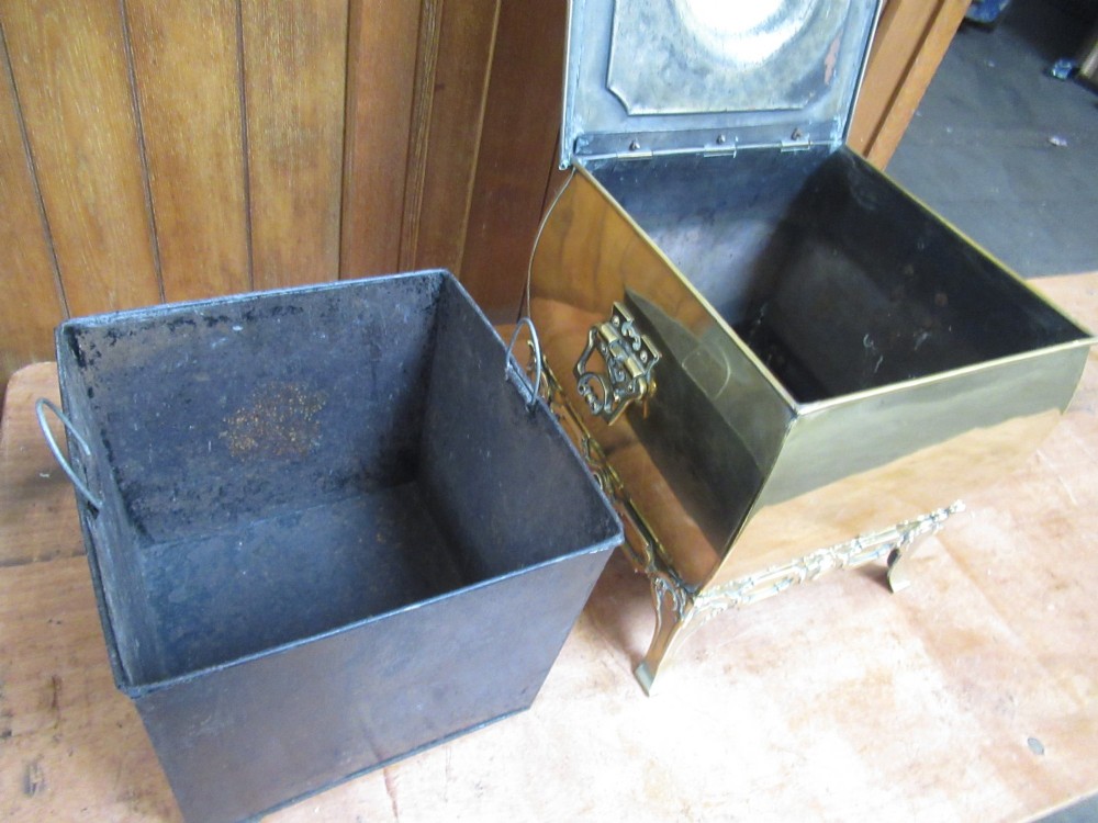 An Edwardian square brass coal box featuring a domed central lid handle, side drop handles, and ornate cast feet. View VII