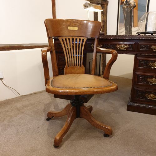light oak leather seated revolving desk chair presented to w deedes by the past present boys in 1912 - CATEGORY: ANTIQUE CHAIRS - DATED EDWARDIAN