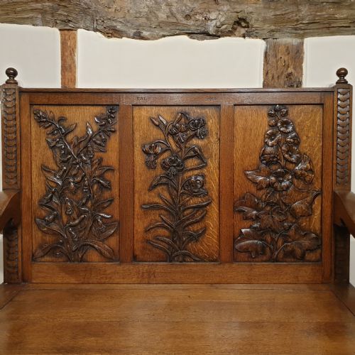 CARVED OAK BOX SETTLE UNIQUELY DECORATED WITH GARDEN FLOWERS INITIALLED DATED 1908 - ADDITIONAL PHOTO 1