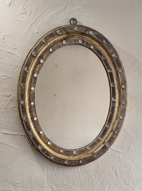 a 19th century irish gilt embossed oval wall mirror - CATEGORY: ANTIQUE MIRRORS - DATED 19TH CENTURY