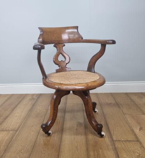AN OAK SWIVEL DESK CHAIR WITH HEART SHAPED BACK - ADDITIONAL PHOTO 1
