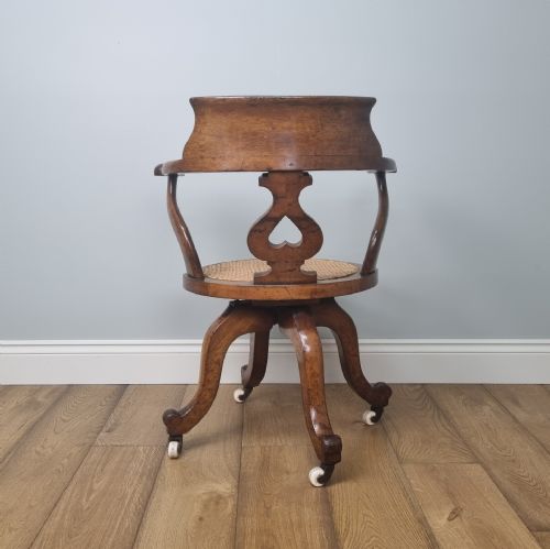 AN OAK SWIVEL DESK CHAIR WITH HEART SHAPED BACK - ADDITIONAL PHOTO 9