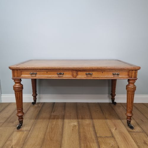 A FINE GOLDEN OAK WRITING TABLE BY JOHNSTONE JEANES CO