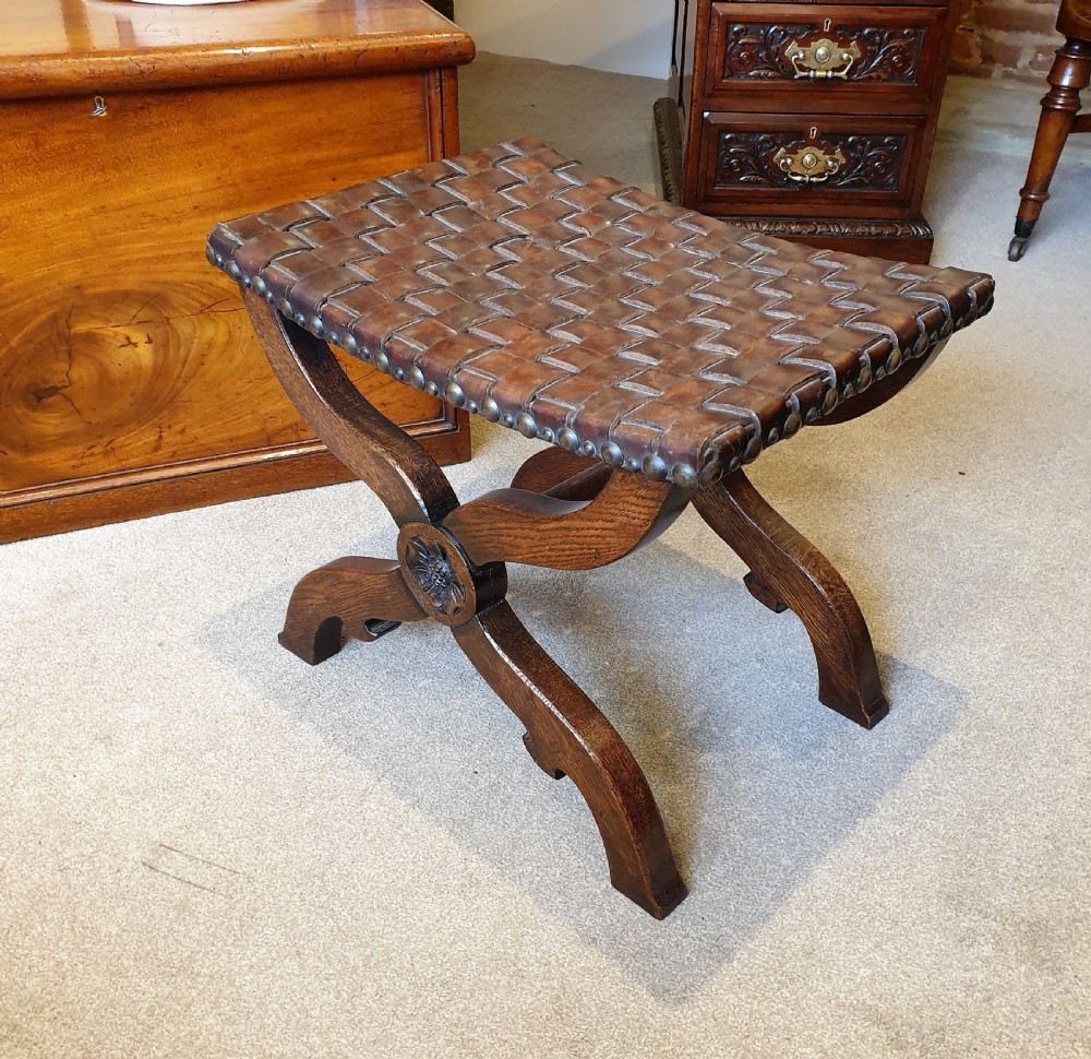 An oak & leather lattice seated Arts & Crafts 'x' frame stool