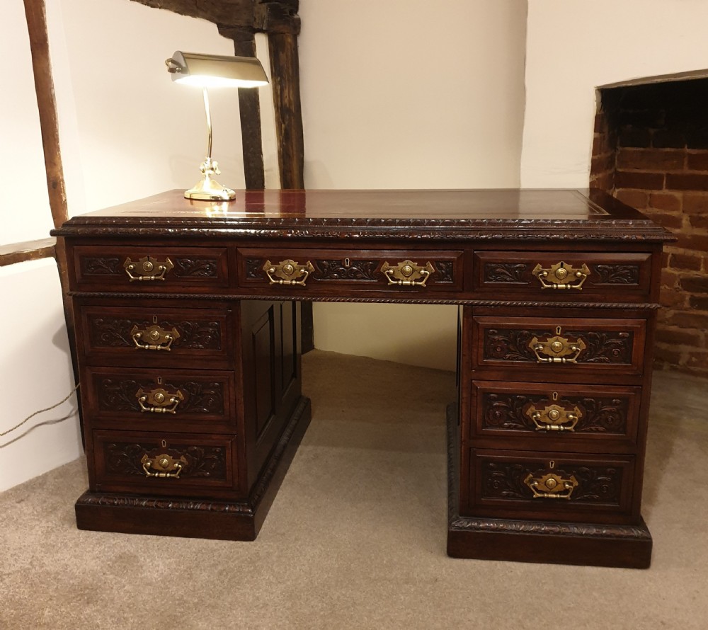 A finely carved & panelled mahogany pedestal desk 