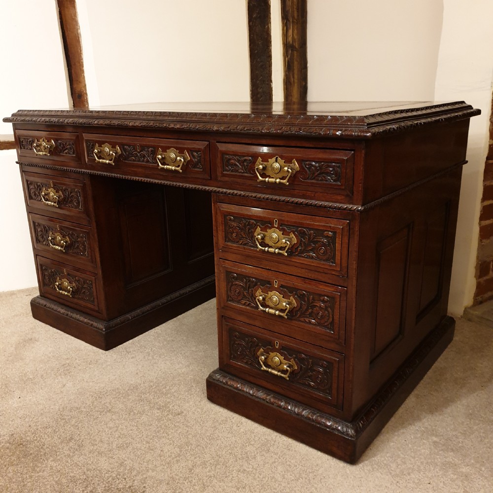 A finely carved & panelled mahogany pedestal desk  View II