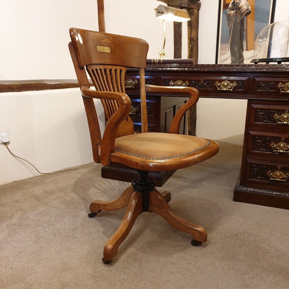 Light oak & leather seated revolving desk chair - presented to W Deedes by the past & present boys in 1912 View II