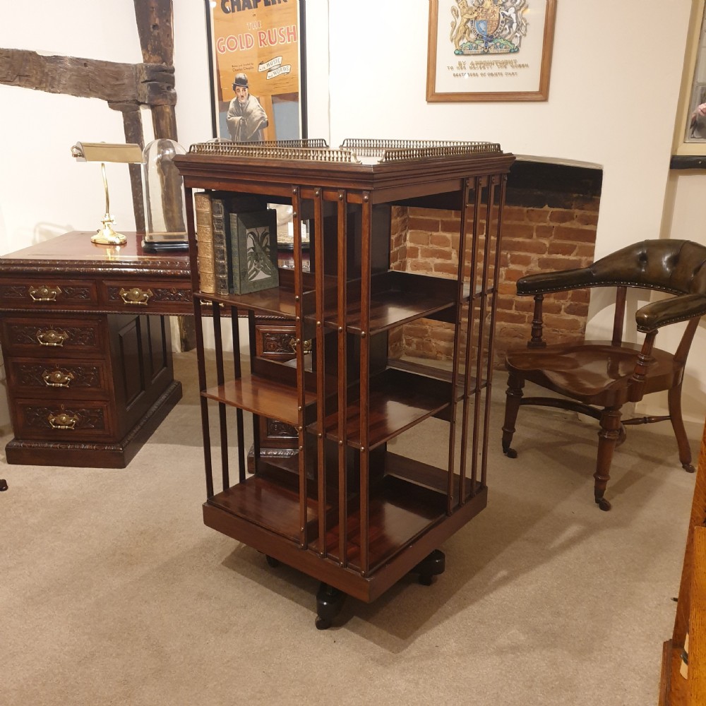 A mahogany revolving library bookcase with galleried top. 