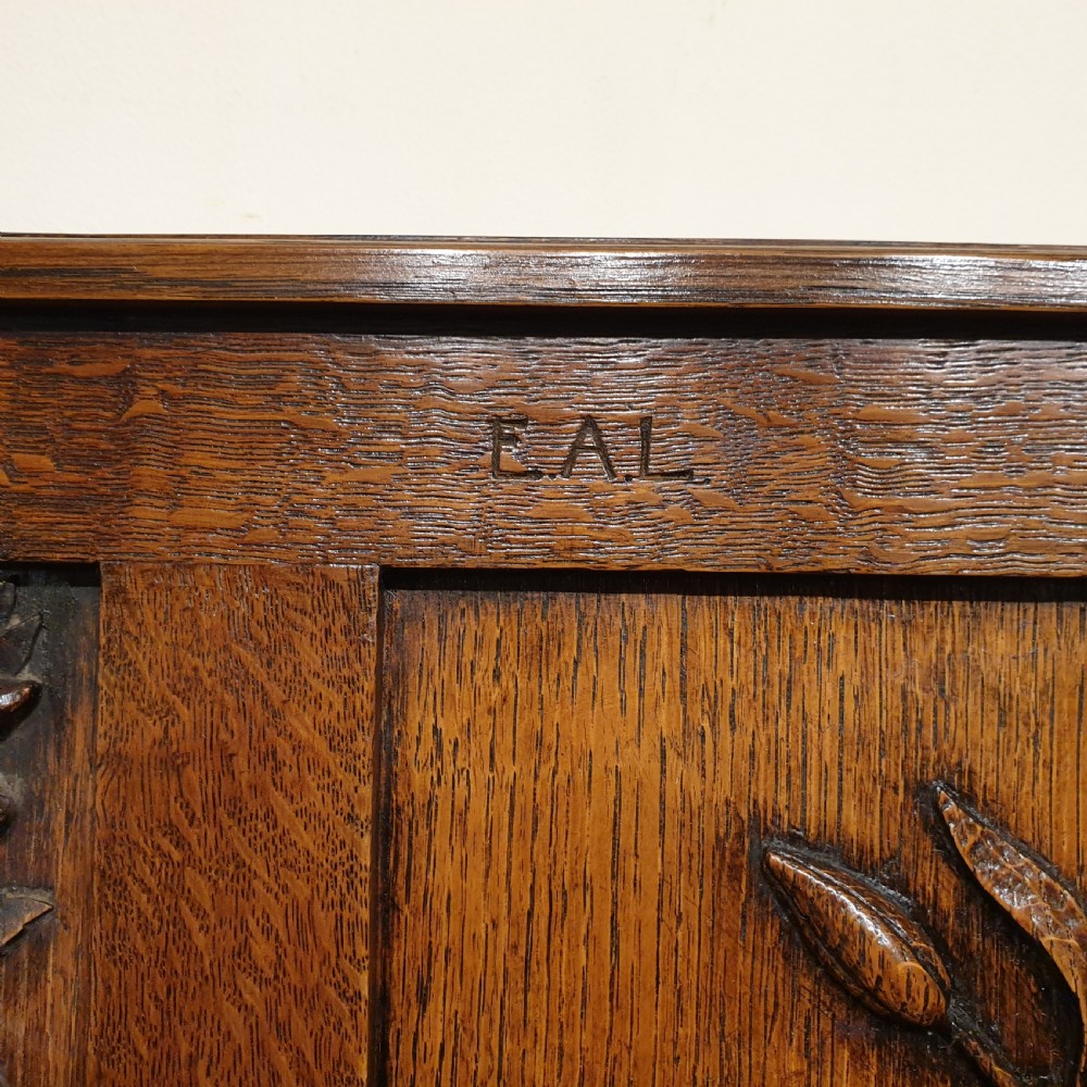 Carved oak box settle - uniquely decorated with garden flowers - initialled & dated 1908 View III