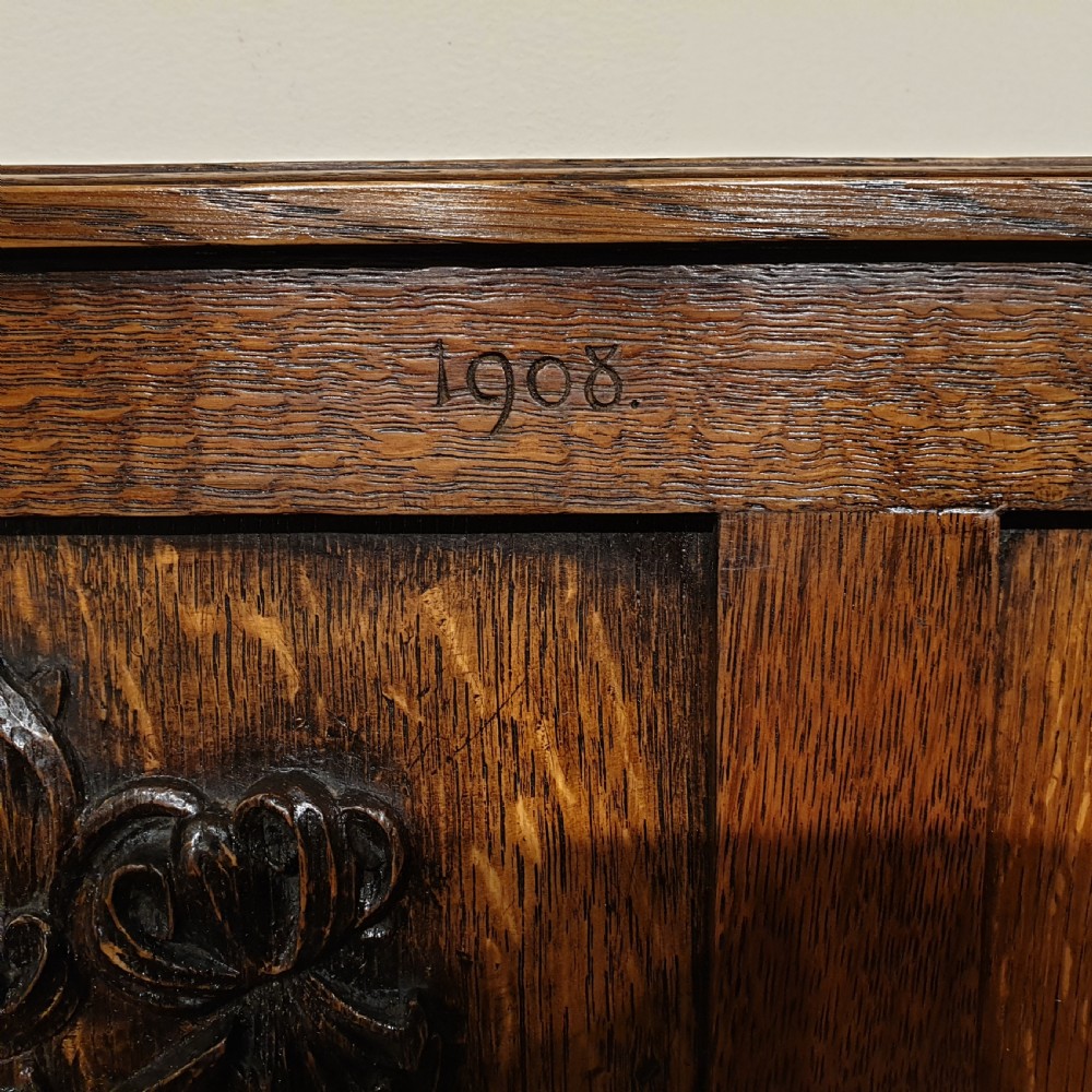 Carved oak box settle - uniquely decorated with garden flowers - initialled & dated 1908 View IV
