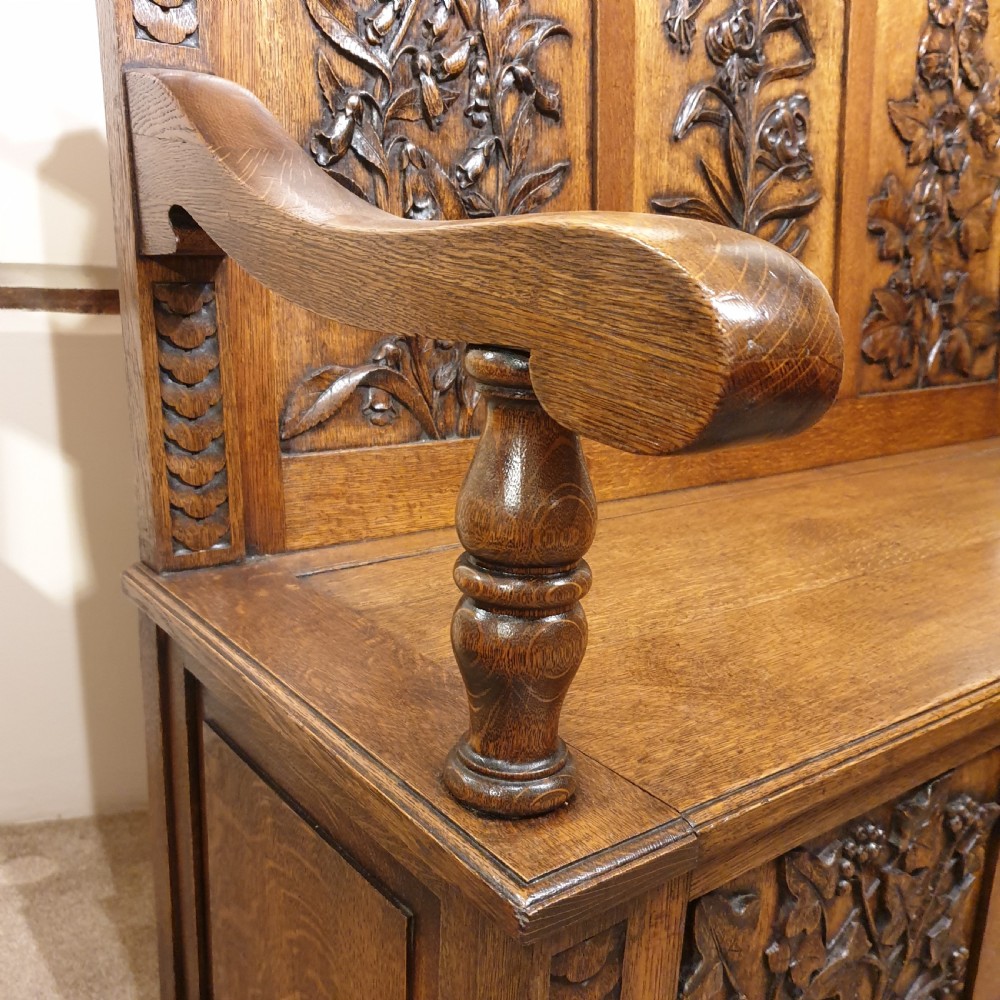 Carved oak box settle - uniquely decorated with garden flowers - initialled & dated 1908 View VI
