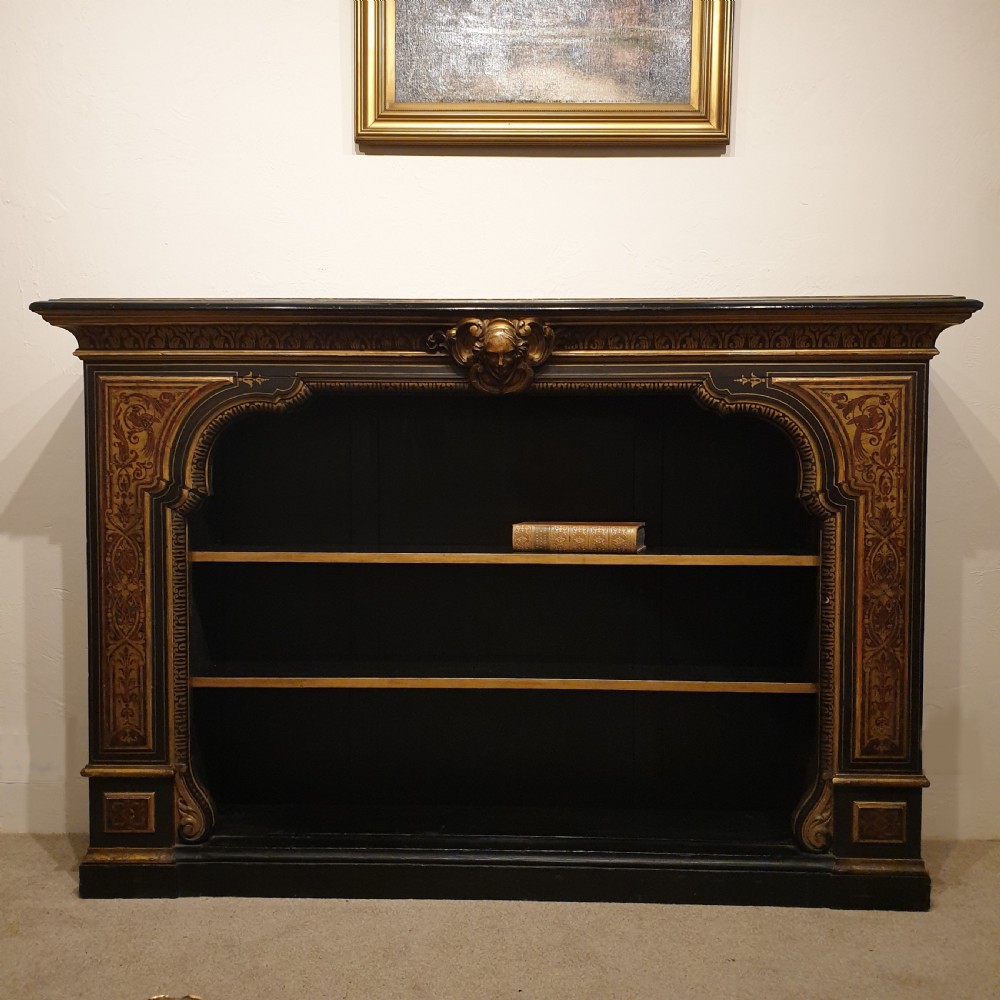 An ebonised open bookcase with gilded & faux boulle decoration