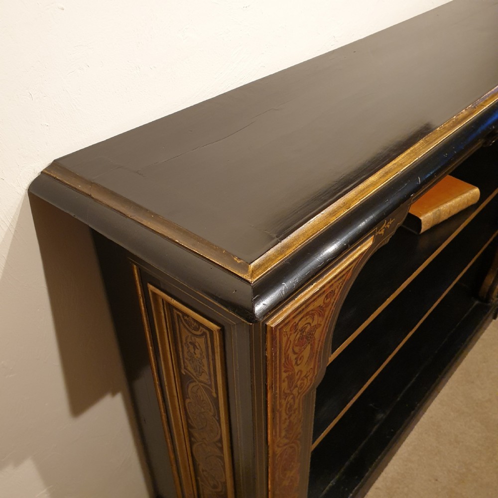 An ebonised open bookcase with gilded & faux boulle decoration View IV