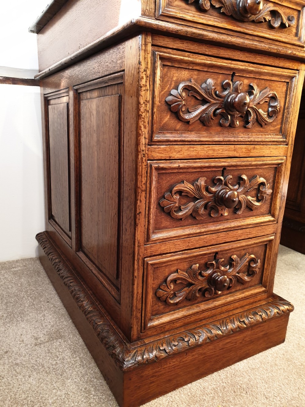 A fine panelled oak pedestal desk by Wetson & Thexton of Tottenham Court Road, London.  View II