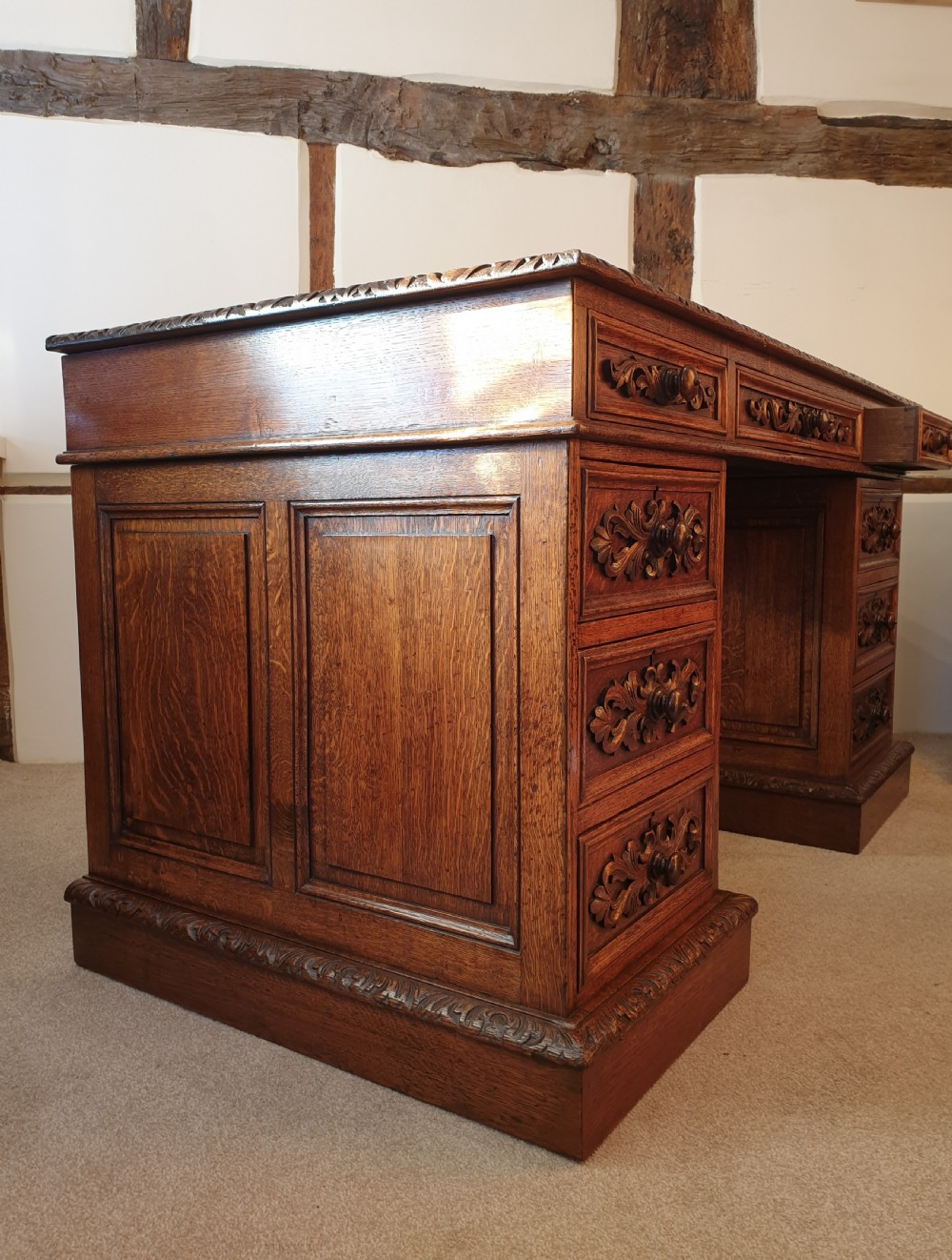 A fine panelled oak pedestal desk by Wetson & Thexton of Tottenham Court Road, London.  View VI