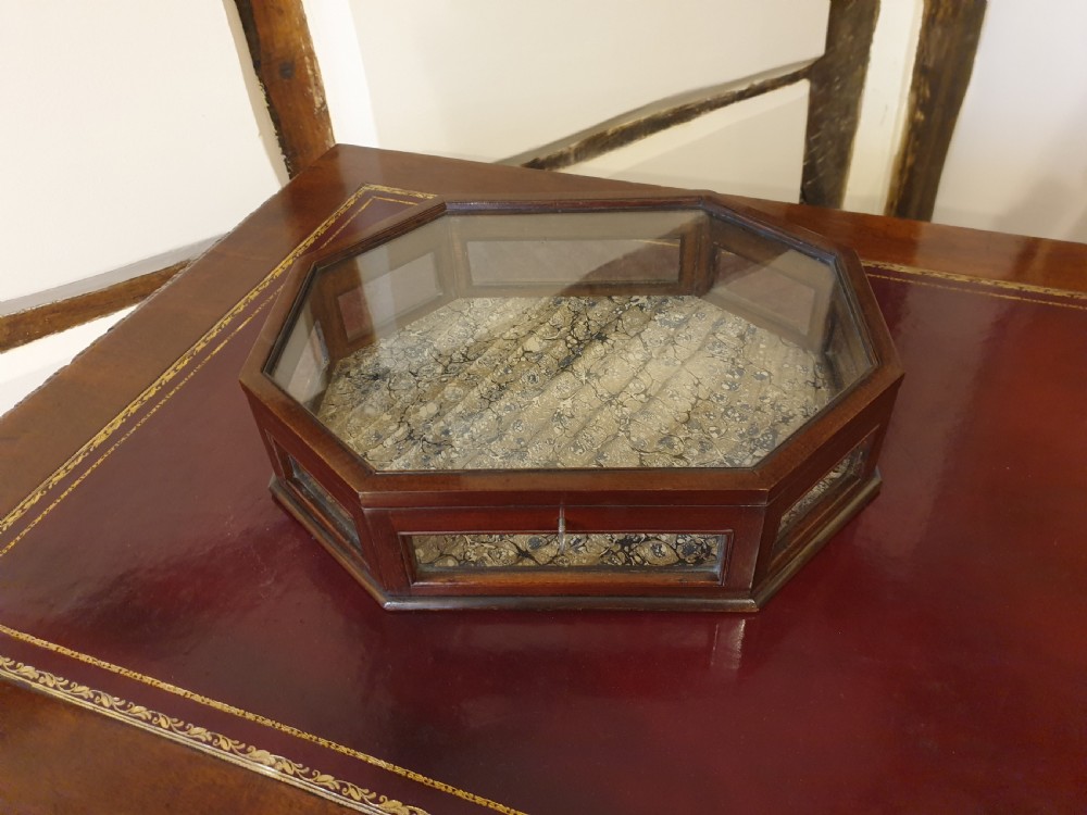 An octagonal mahogany & glass sided table-top display case