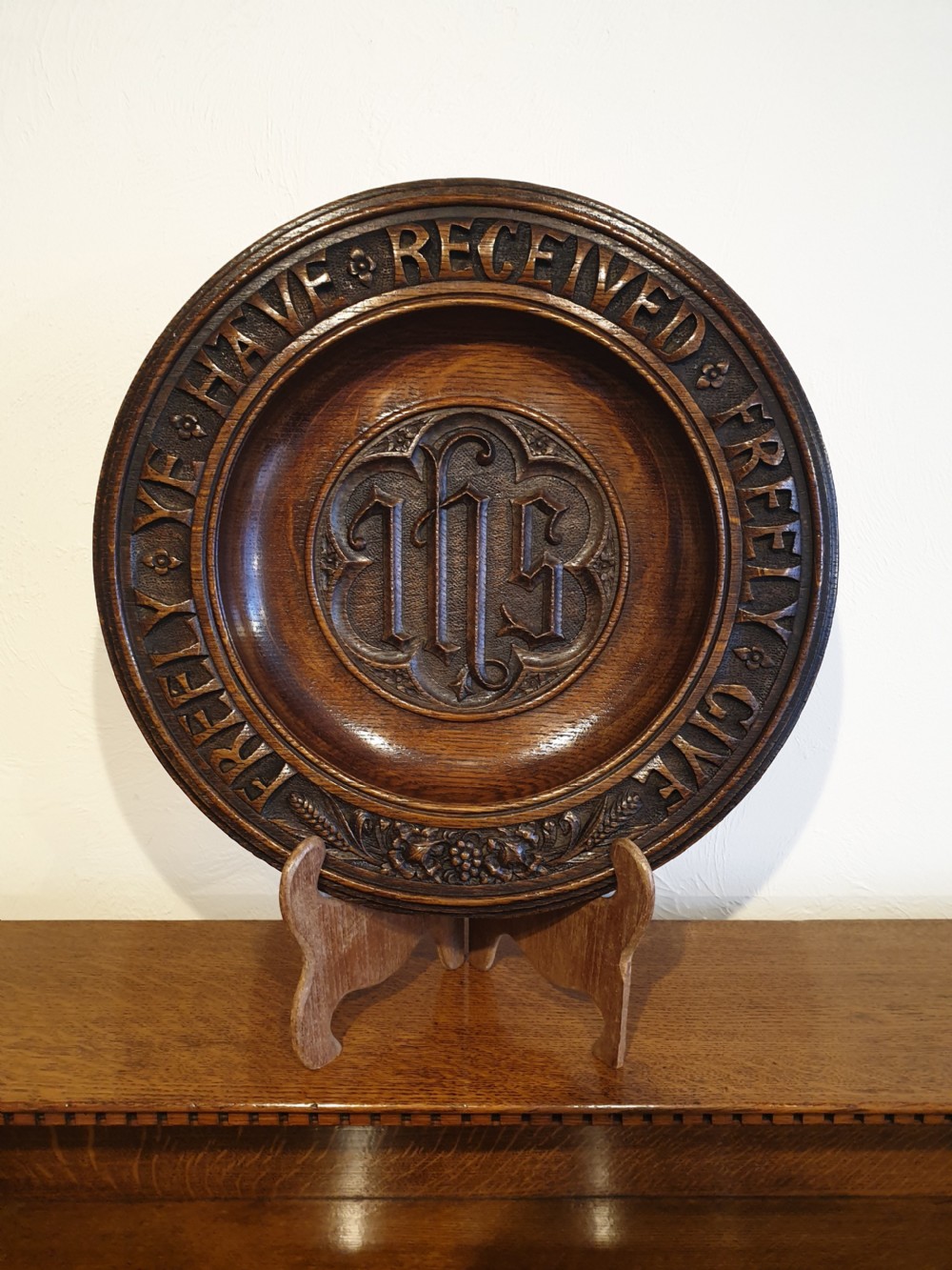 An finely carved and decorated oak alms dish 